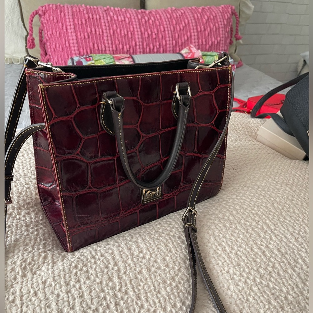 SOLD SOLD Dooney and Bourke leather shoulder bag. Burgundy with dark brown trim